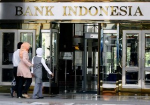 Women walk toward the entrance of Indonesia's central bank building in Jakarta