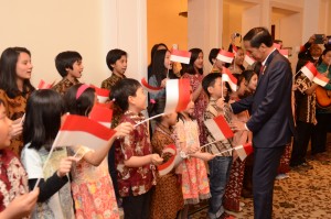 Sejumlah anak-anak Indonesia menyanyikan lagu "Berkibarlah Benderaku" menyambut kedatangan Presiden Jokowi di Berlin, Minggu (17/4) malam waktu setempat. (Foto: Humas/Deni)