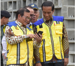 Presiden Jokowi tampak tersebut melihat handphone yang ditunjukkan Seskab, saat menghadiri Peluncuran Sertifikasi Elektrik dan Sertifikasi Tenaga Kerja Konstruksi Indonesia di Istora Gelora Bung Karno, Senayan, Jakarta Selatan, Selasa (12/3) siang. (Foto: OJI/Humas)