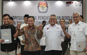 Komisioner KPU dan Bawaslu bergandengan tangan usai mengumumkan hasil rekapitulasi nasional Pilpres ddan Pileg 2019, di Kantor KPU, Jakarta, Selasa (21/5) dinihari. (Foto: ANT)