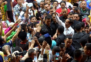 Presiden Jokowi menyapa warga yang memenuhi GOR Tri Dharma PT Petrokimia, Kabupaten Gresik, Jawa Timur, Kamis (20/6) siang, untuk menghadiri acara penyerahan sertifikat. (Foto: Rahmad/Humas)